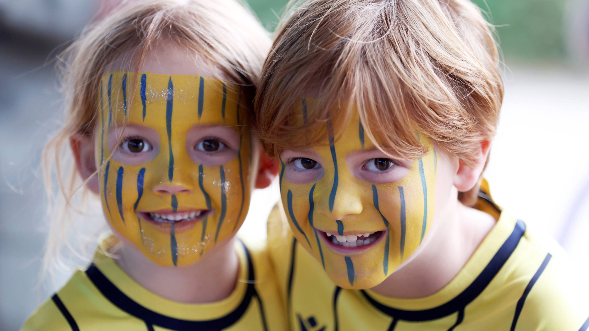 Two young Oxford United fans with their faces painted